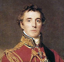 Head and shoulders portrait of middle-aged man looking towards the viewer. He wears a red tunic with gold braid finishing.