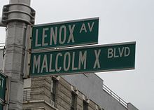 Two green street signs, one reading Lenox Avenue, the other reading Malcolm X Boulevard