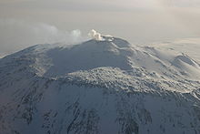 Distant view of a mountain with a smoke emission from its summit